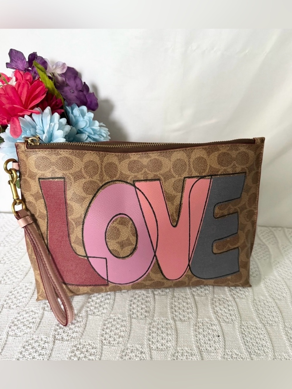 Coach Signature Canvas Love Print Rowan Pouch colorful block-style “LOVE”